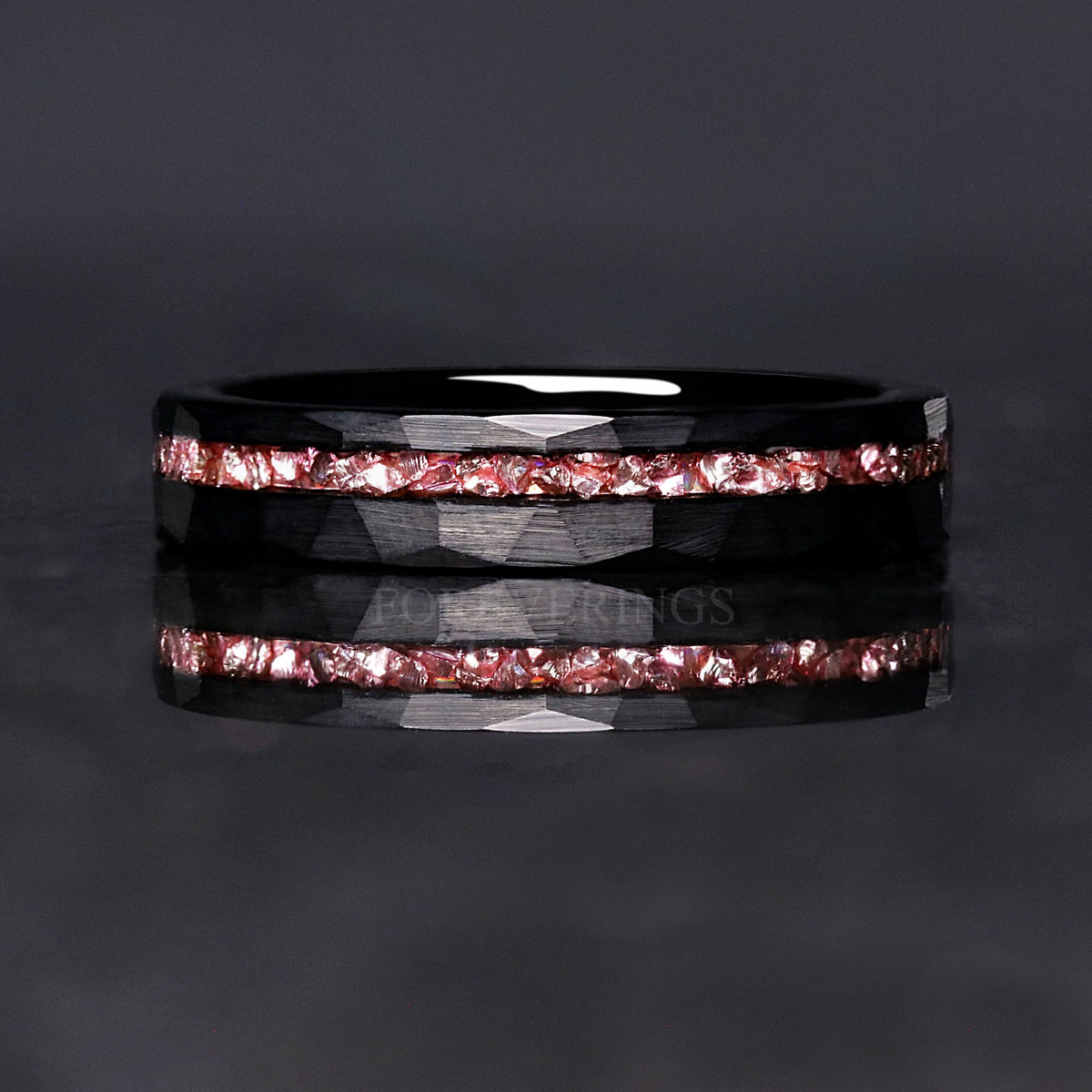 Black tungsten morganite band shown straight on, pink crushed stripe across the face