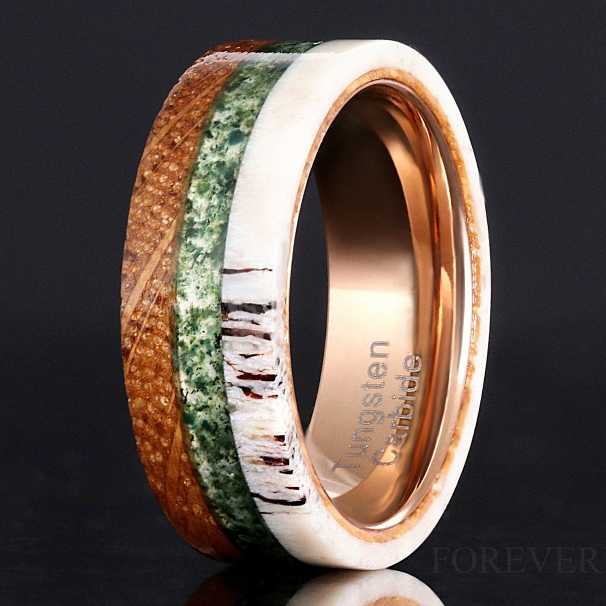 Men's 8mm rose gold tungsten ring with whiskey barrel wood, moss agate and antler inlay, standing upright