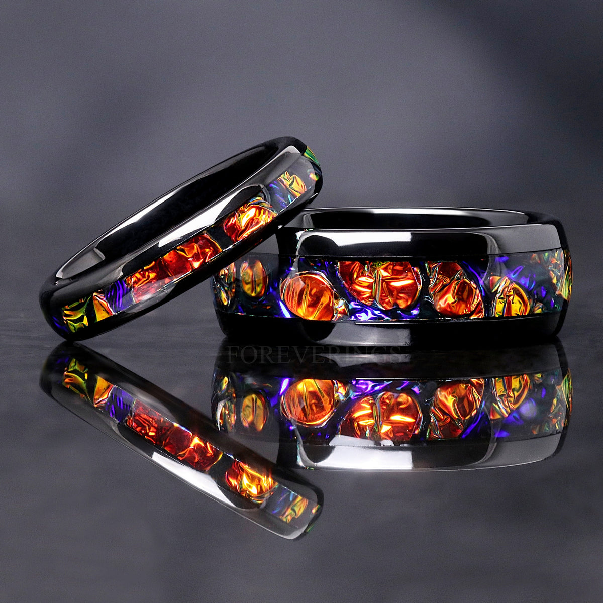 Matching black tungsten couples ring set with red and orange dichrolam inlay, 8mm and 4mm