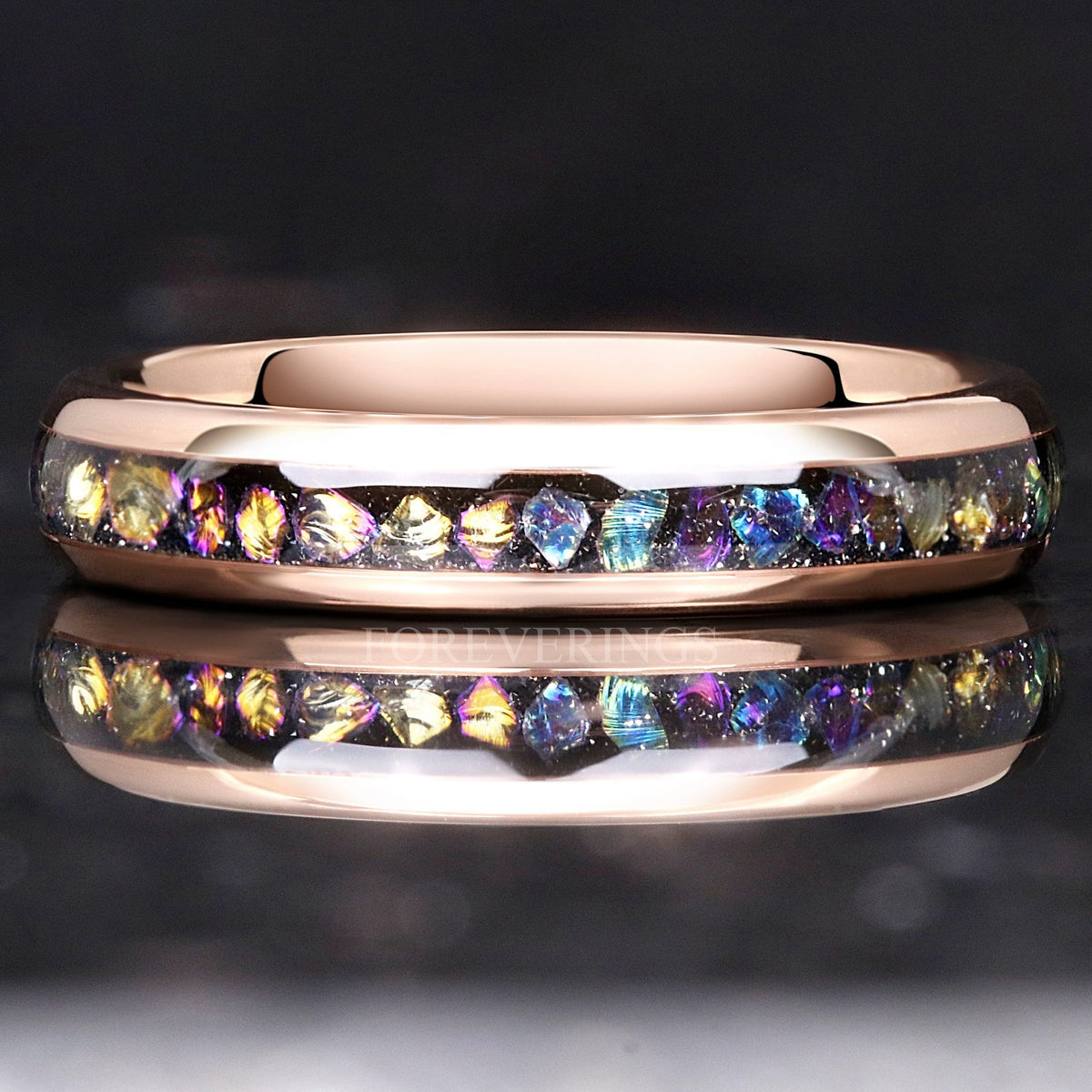 4mm rose gold tungsten ring with Veil Nebula moonstone inlay, lying flat with reflection
