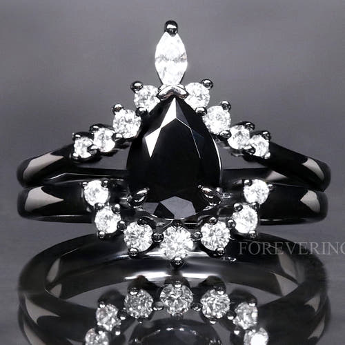 Women's black onyx bridal set: pear-cut engagement ring nested with a curved band of white stones