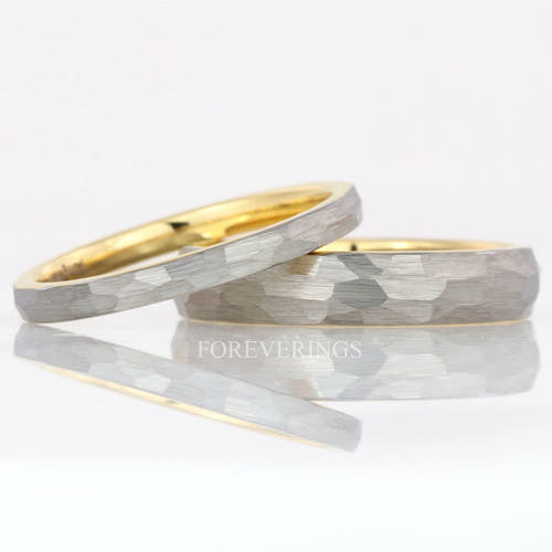 Hammered silver and gold two-tone tungsten bands in 2mm and 4mm, the thin one leaning on the wider