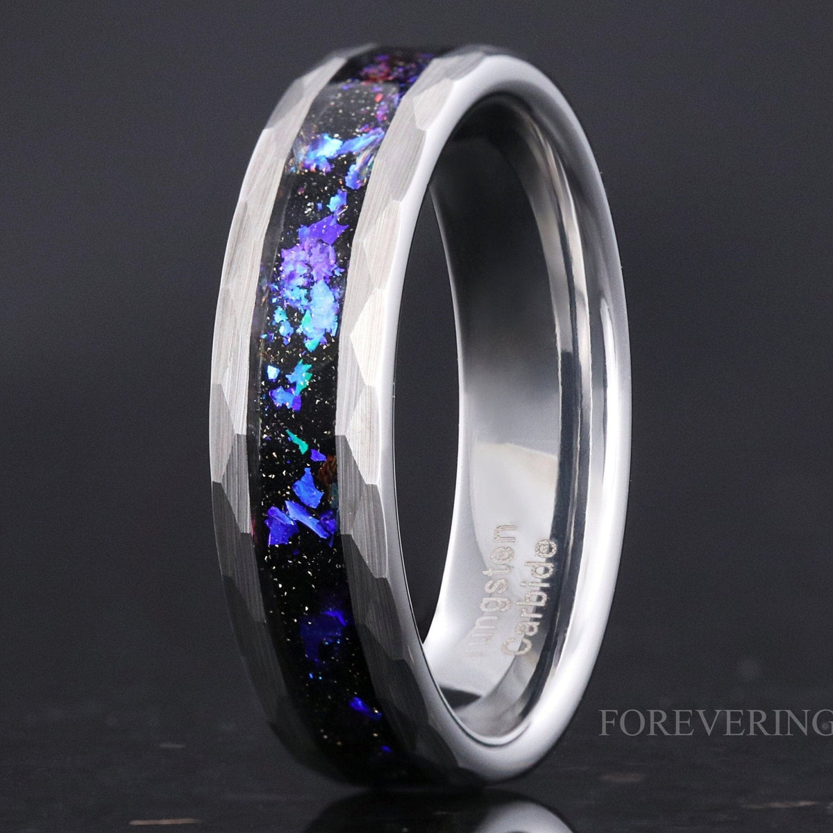 Men's hammered silver tungsten band with Orion nebula sandstone inlay, angled close-up