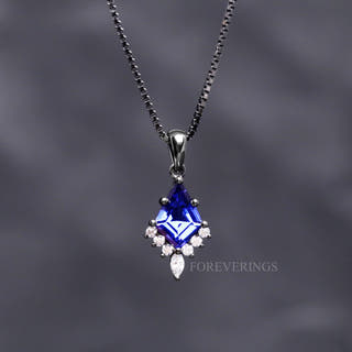 Orion Nebula pendant necklace in black sterling silver with a kite cut blue sapphire on a box chain