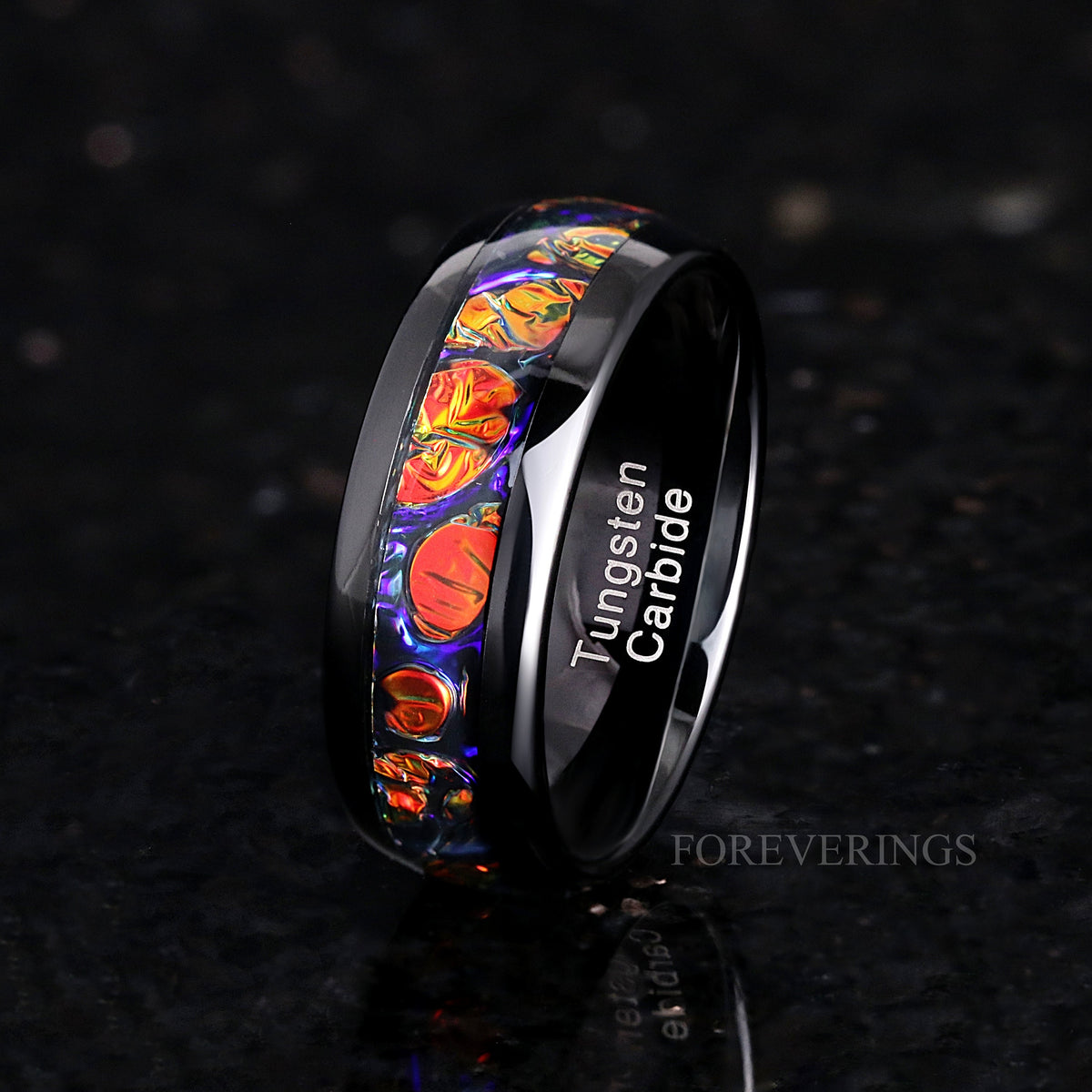 Men's 8mm black tungsten band with red dichrolam inlay, standing at an angle to show the interior