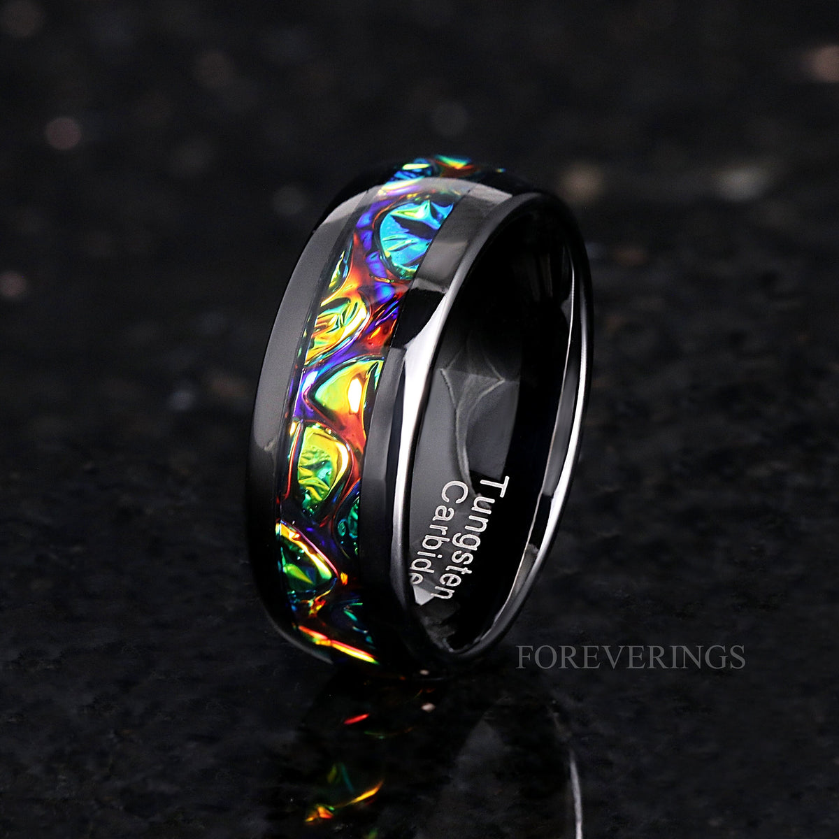 Men's 8mm black tungsten band with rainbow dichrolam inlay, standing on edge