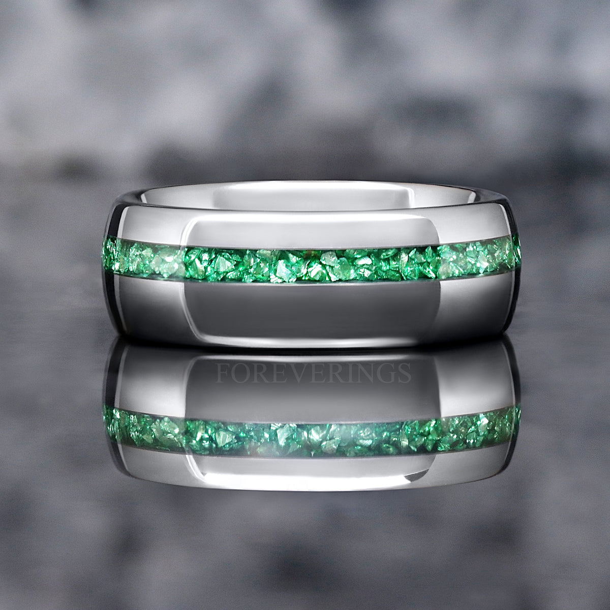 Silver tungsten band with an emerald inlay stripe, front view