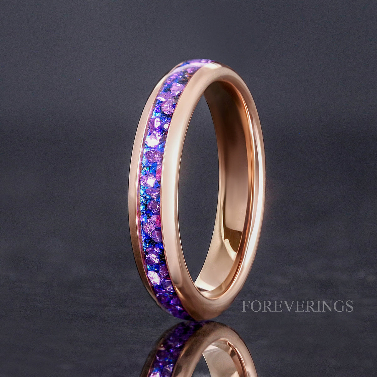 Women's 4mm rose gold tungsten ring with alexandrite inlay, standing on edge