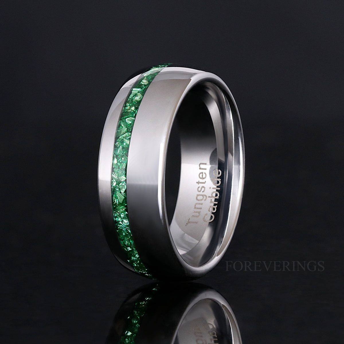 Men's 8mm polished silver tungsten band with emerald inlay, standing on edge