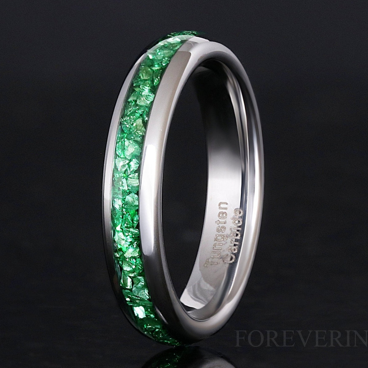 4mm silver tungsten wedding band with green emerald stone inlay, angled view