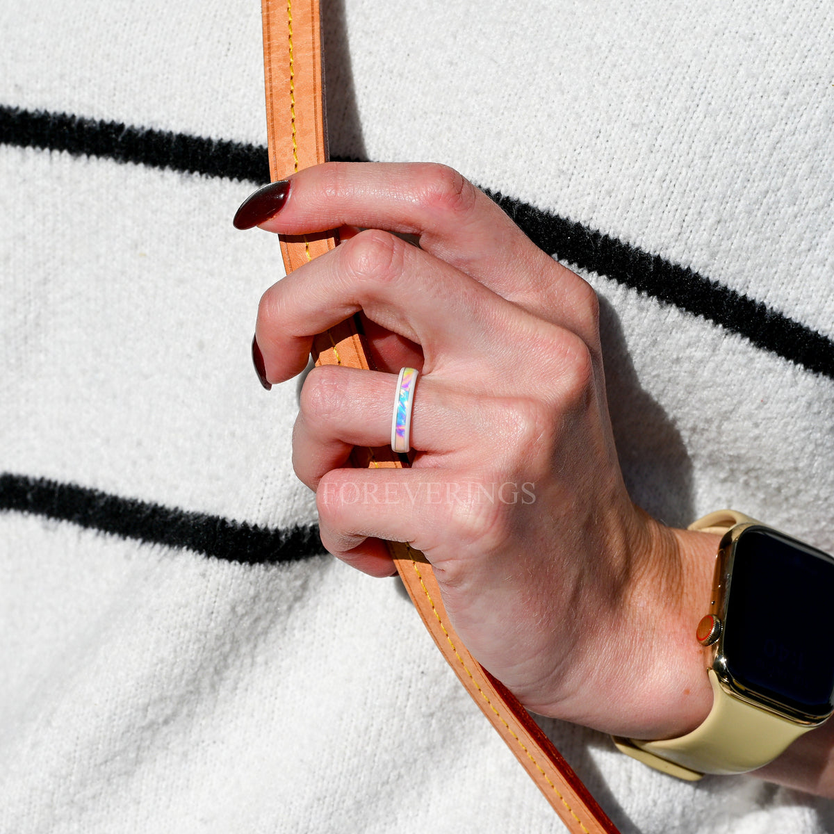 4mm white ceramic ring with dichrolam inlay on a woman's hand, wider view