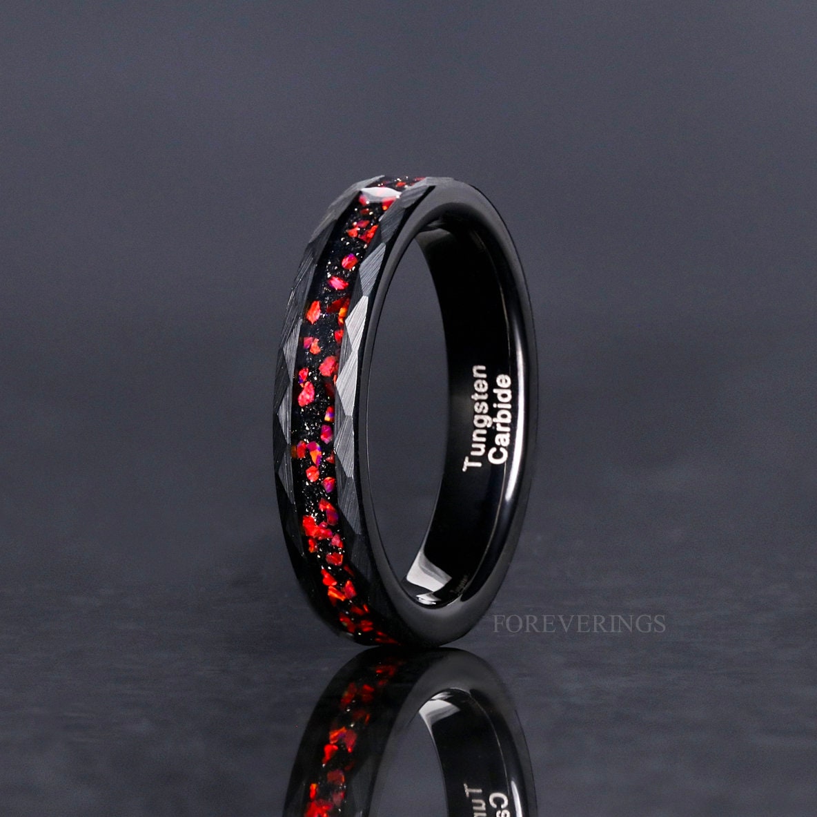 Women's 4mm hammered black tungsten ring with red fire opal inlay, standing upright