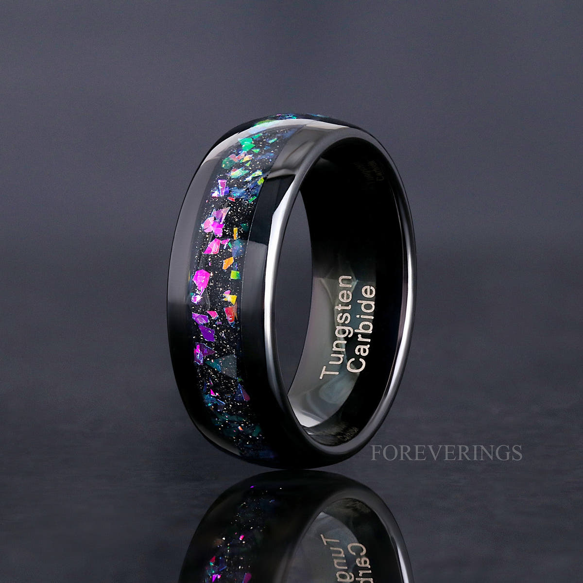 Men's 8mm black tungsten wedding band with supernova-inspired galaxy inlay, standing at an angle