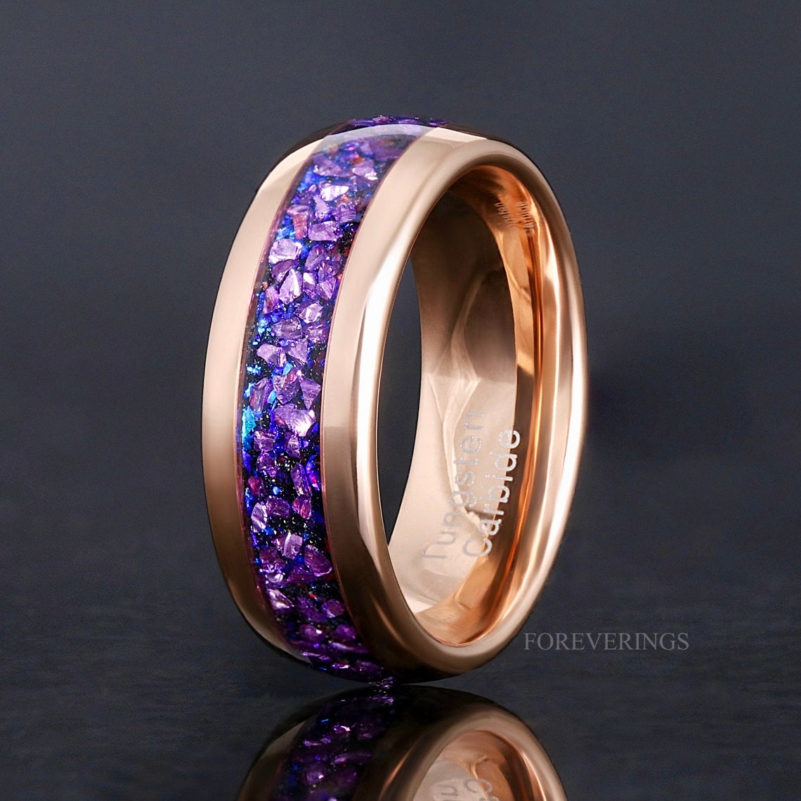 Men's 8mm rose gold tungsten band with crushed alexandrite inlay, standing to show the interior
