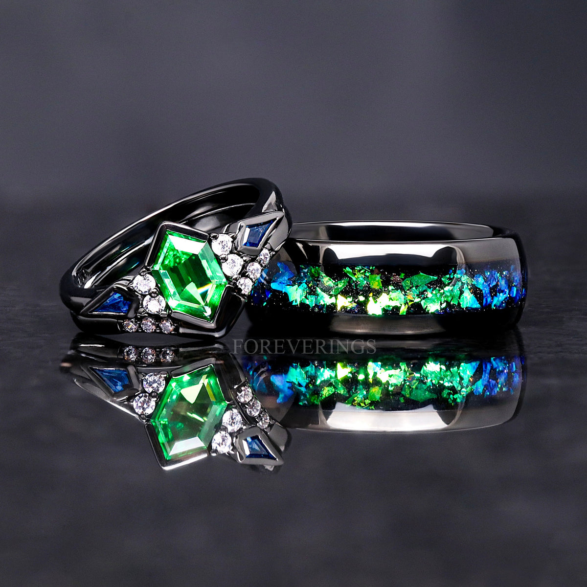 Tsavorite bridal set beside a wider black band with green nebula inlay
