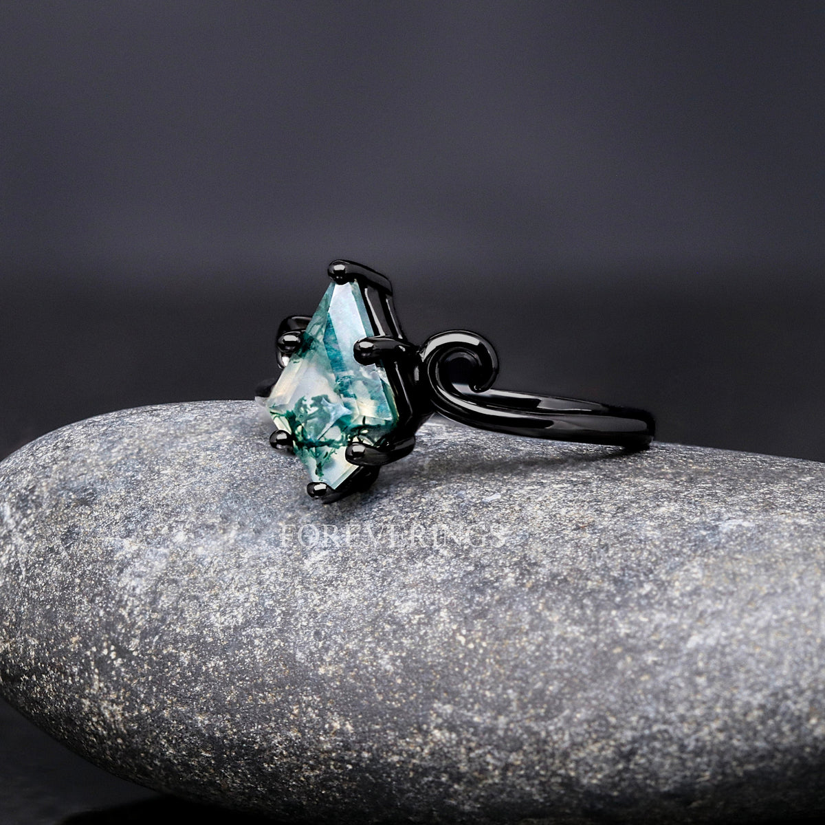 Black twirl moss agate ring at an angle, side view of the kite-cut stone