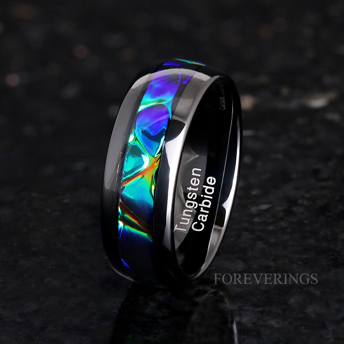 Men's 8mm black tungsten band with iridescent dichrolam inlay, standing at an angle
