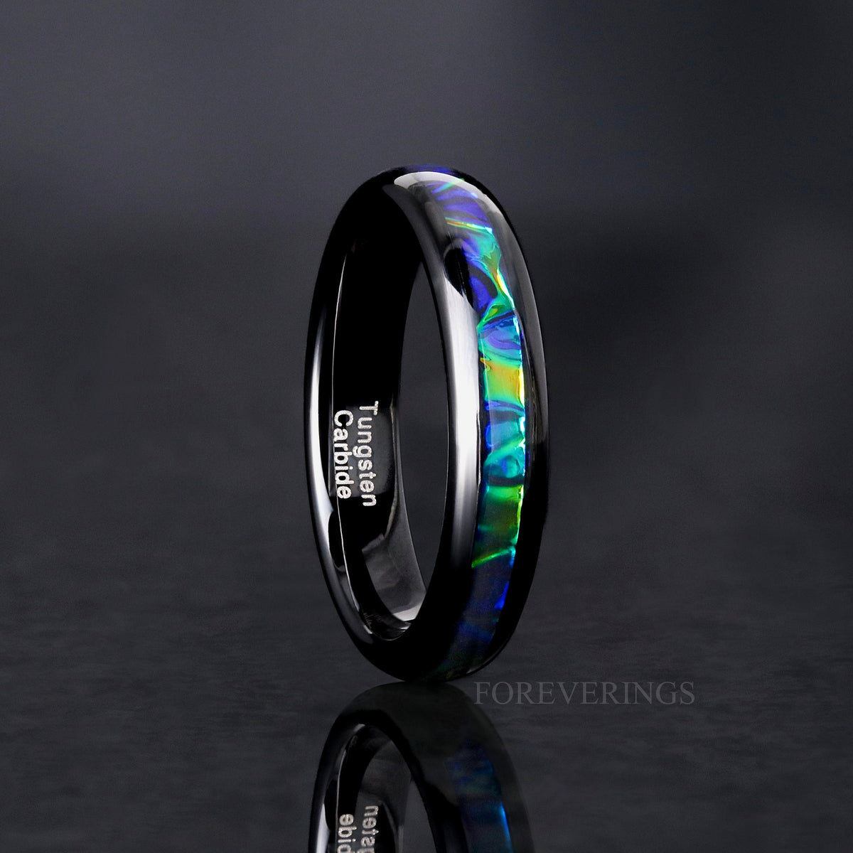 Women's 4mm black tungsten ring with blue and green dichrolam inlay, standing upright