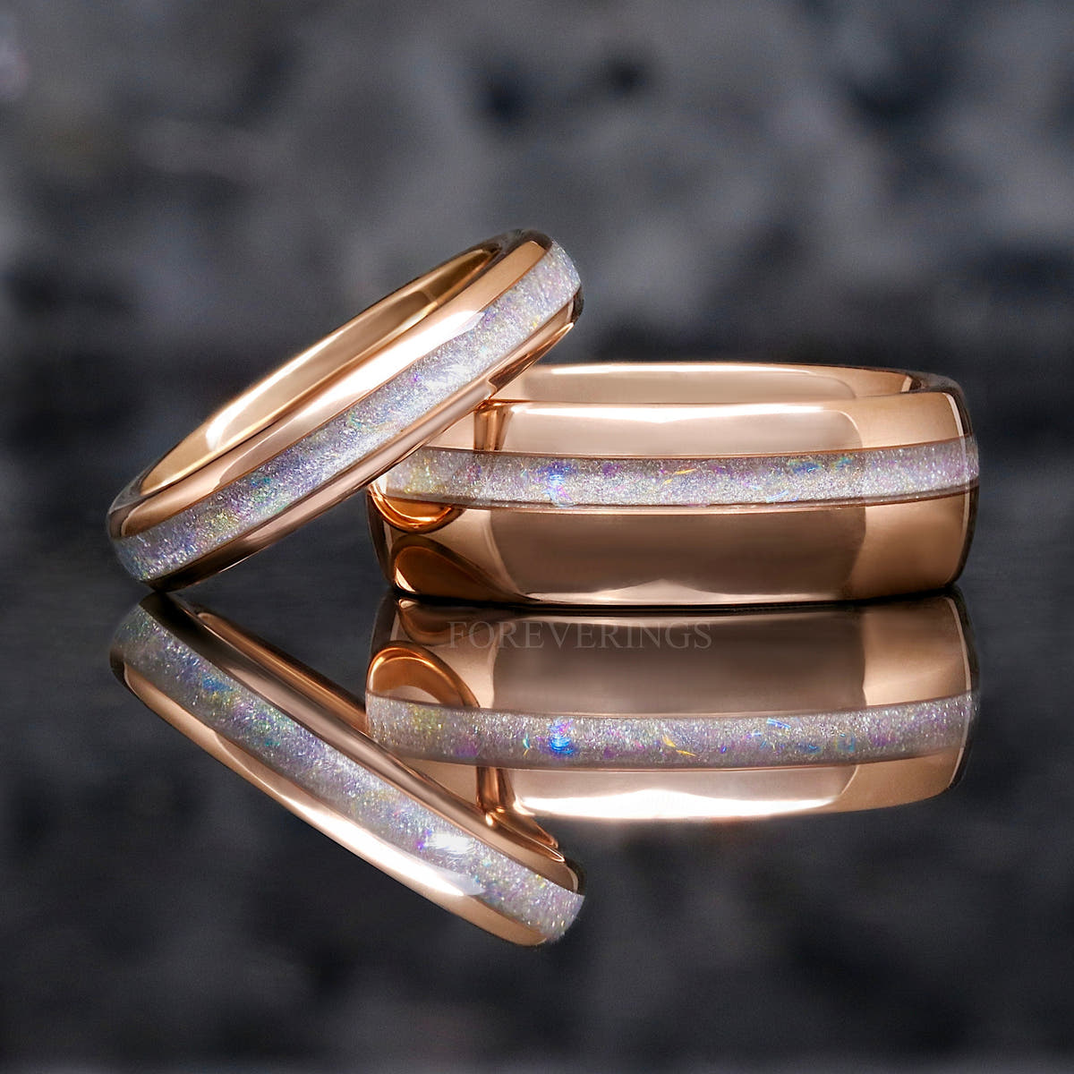 8mm rose gold tungsten moonstone ring with a thinner moonstone ring leaning on it