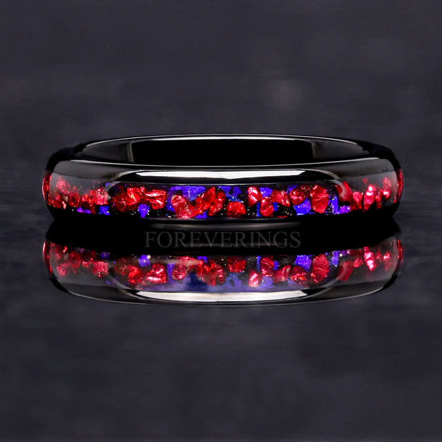 4mm black tungsten band lying flat, front view of the crushed ruby and blue sandstone inlay