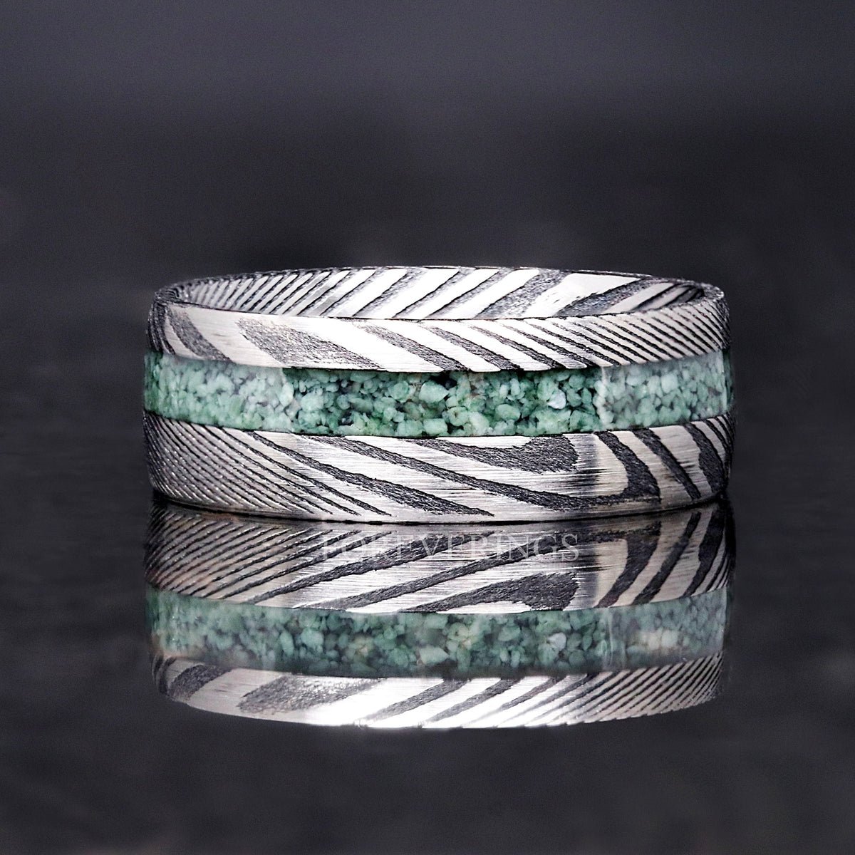 Men's Damascus steel moss agate ring shown straight on, showing the layered steel pattern