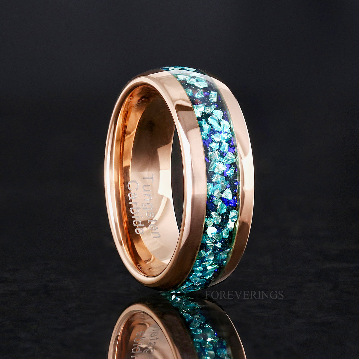 8mm rose gold tungsten band with crushed aquamarine inlay standing at an angle to show the interior
