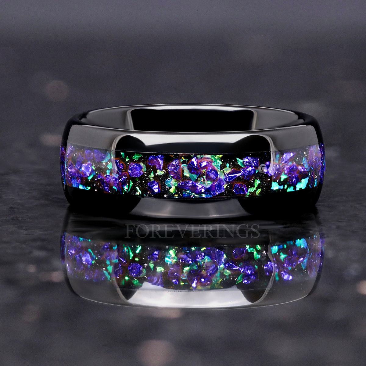 Black tungsten wedding band with purple and green nebula inlay, straight on in a wider view