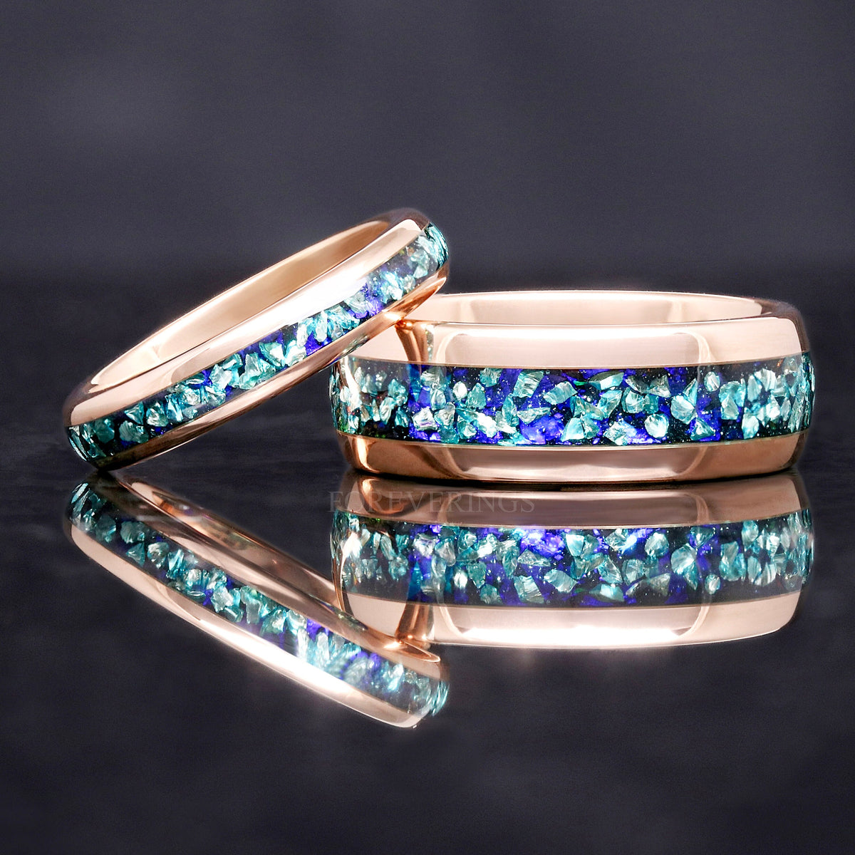 8mm rose gold tungsten band with crushed aquamarine inlay and a thinner aquamarine band leaning on it
