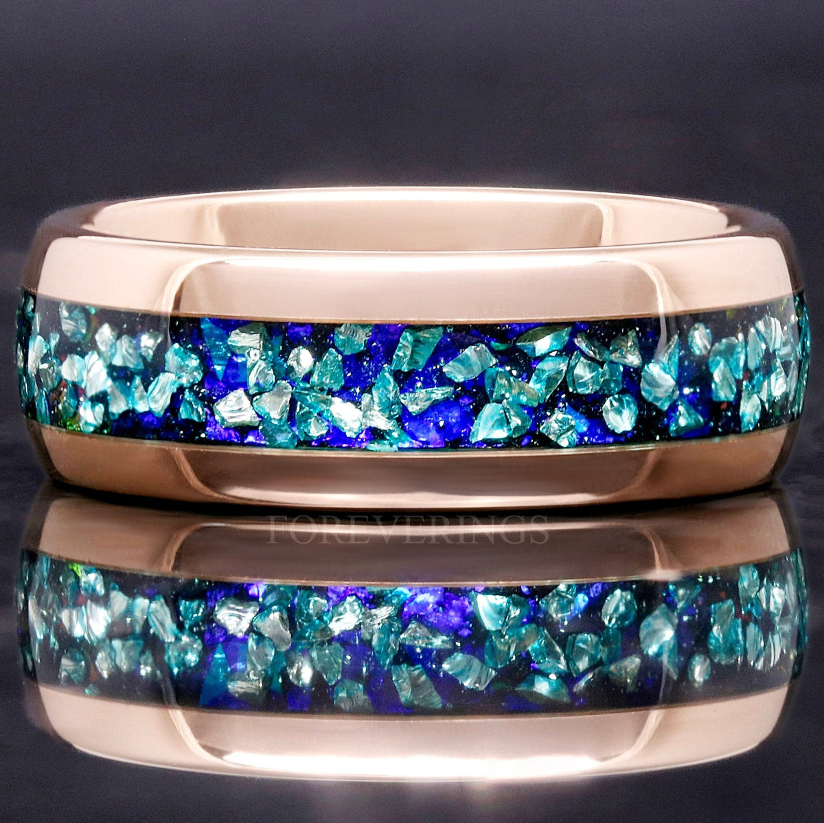 Men's 8mm rose gold tungsten wedding band with crushed aquamarine inlay, straight on in a close crop