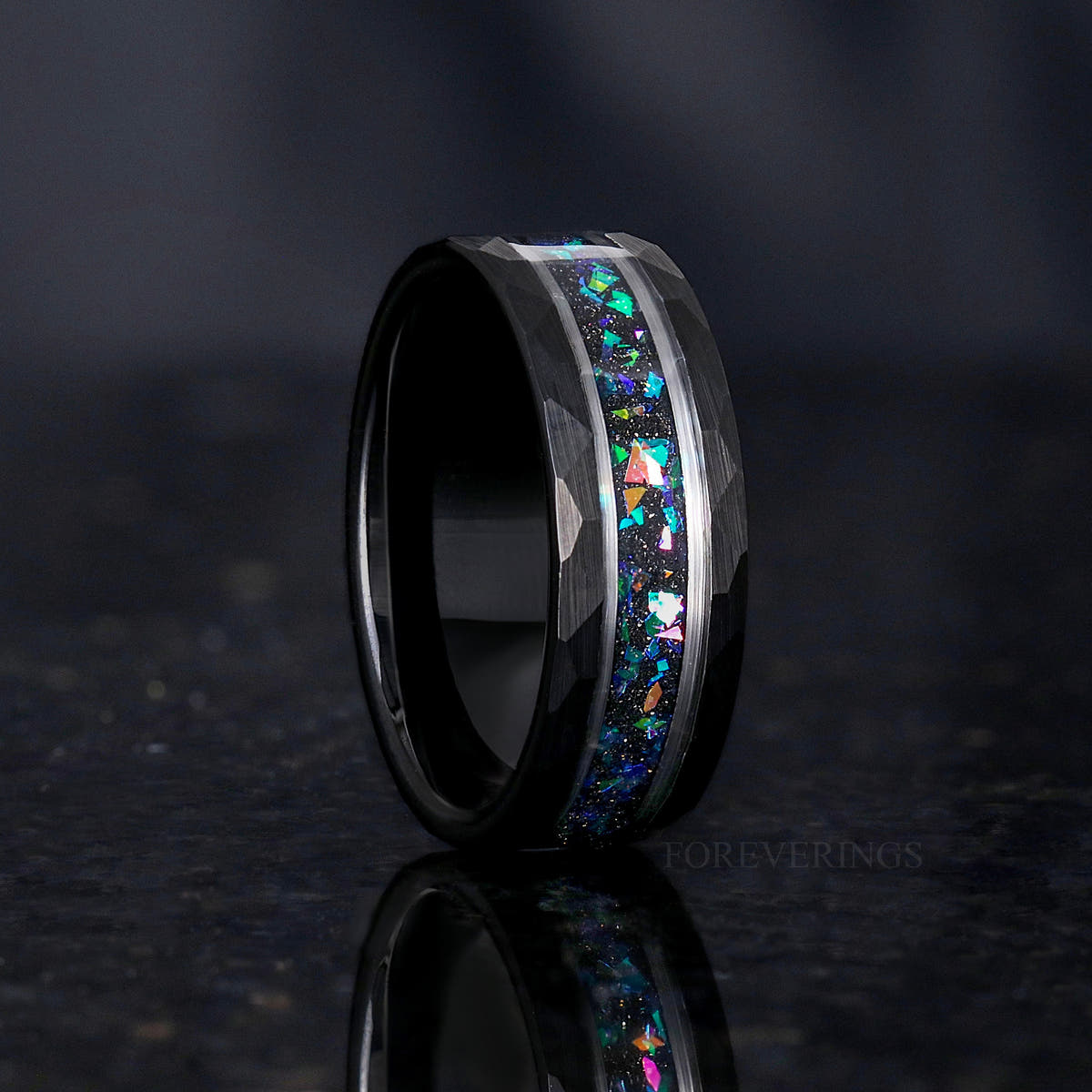 Men's 8mm black and silver tungsten wedding band with nebula-inspired crushed stone inlay, standing angled