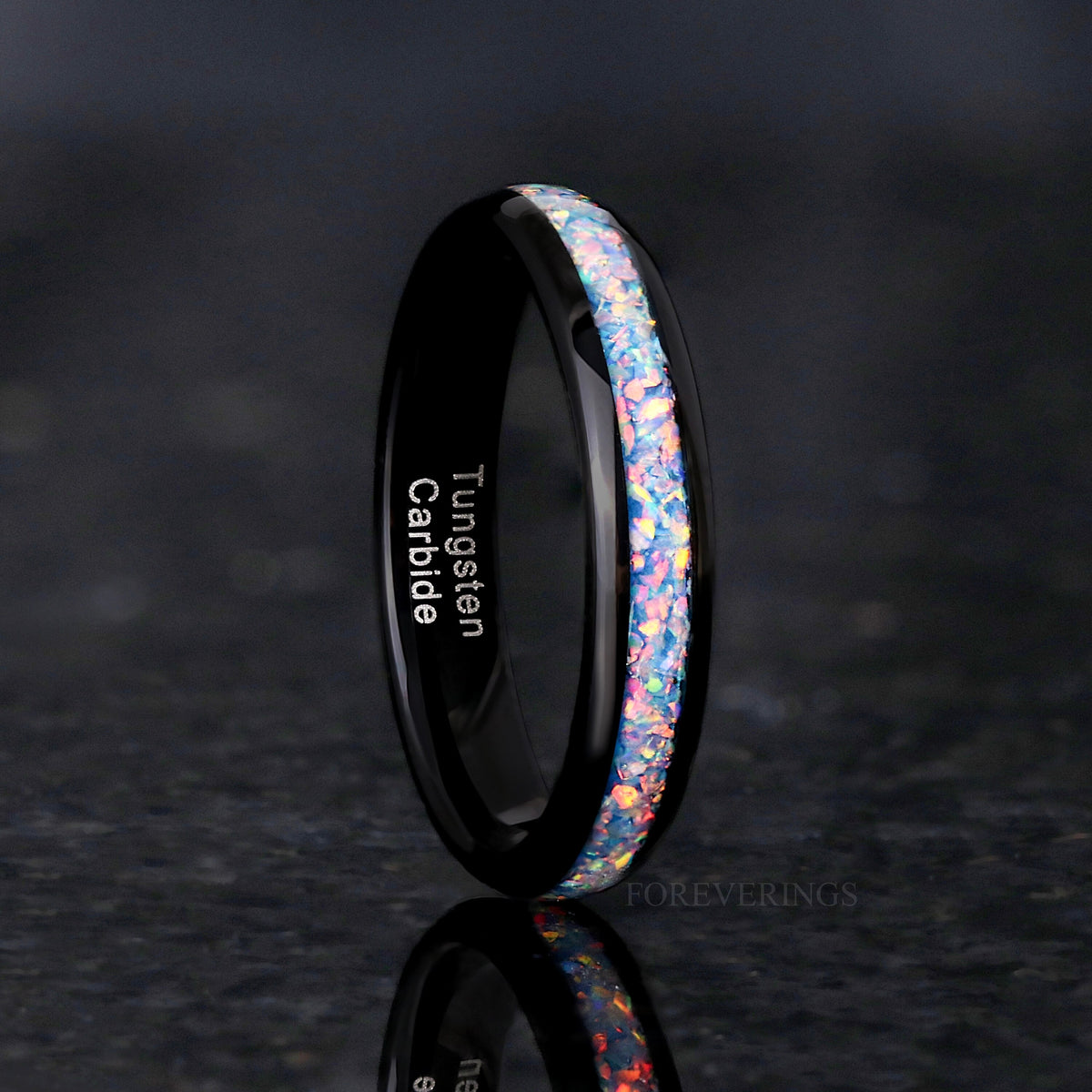 Women's 4mm black tungsten ring with rainbow fire opal inlay, standing upright