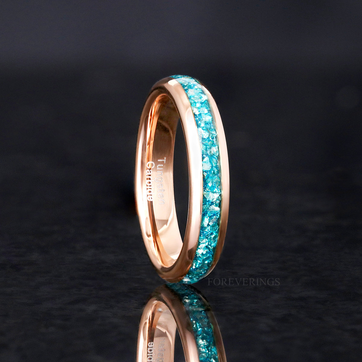 Women's 4mm rose gold tungsten ring with crushed aquamarine inlay, standing on edge
