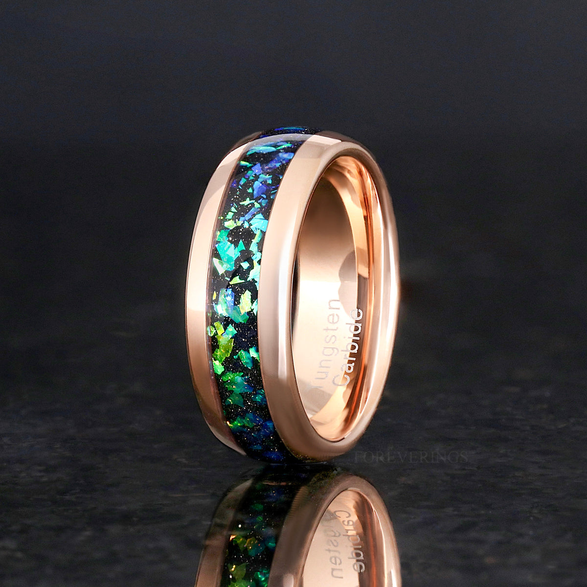8mm rose gold tungsten band with nebula inlay standing on edge, angled with reflection below