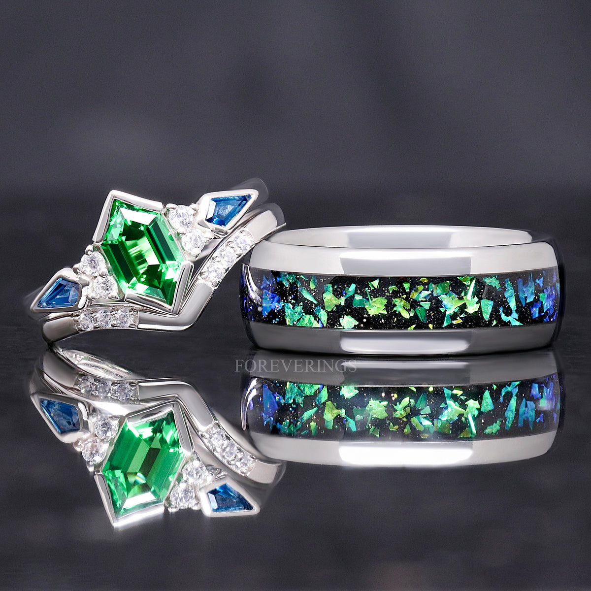 Silver nebula wedding band beside a silver tsavorite bridal set, reflection below
