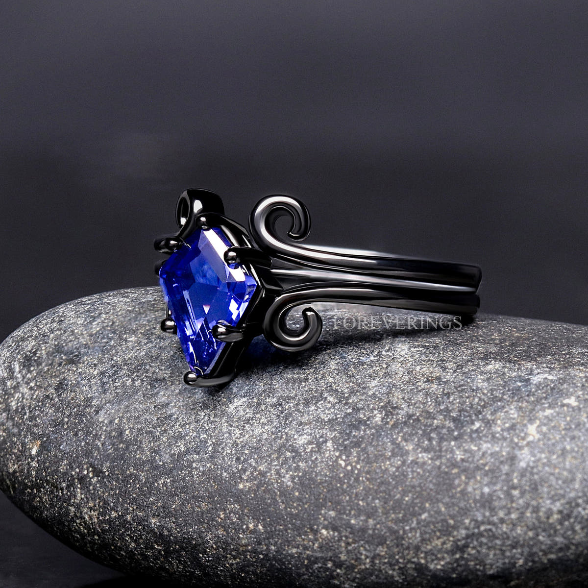 Black sterling silver sapphire engagement ring and swirl band, angled side view