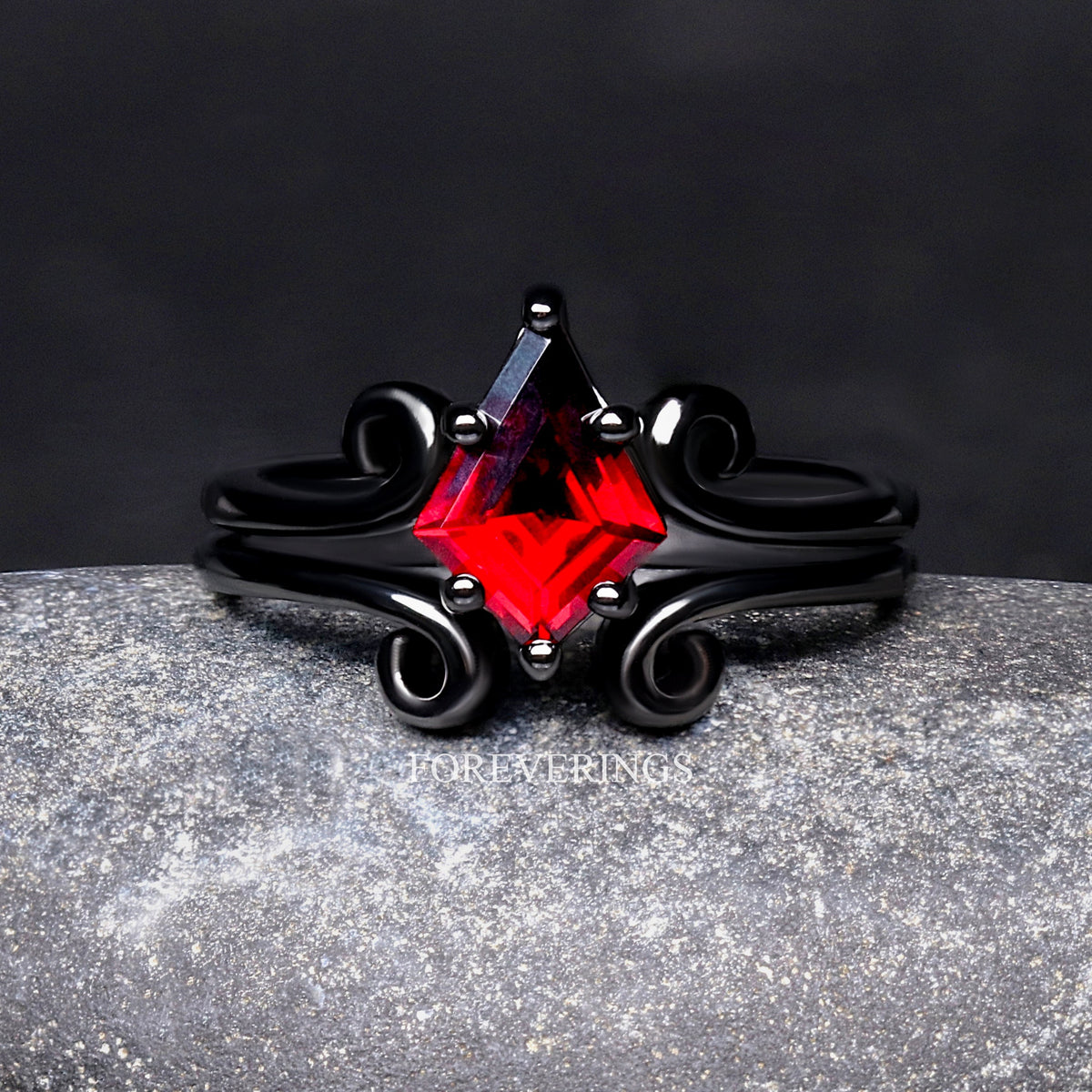 Women's kite-cut red garnet ring in black sterling silver, shown straight on