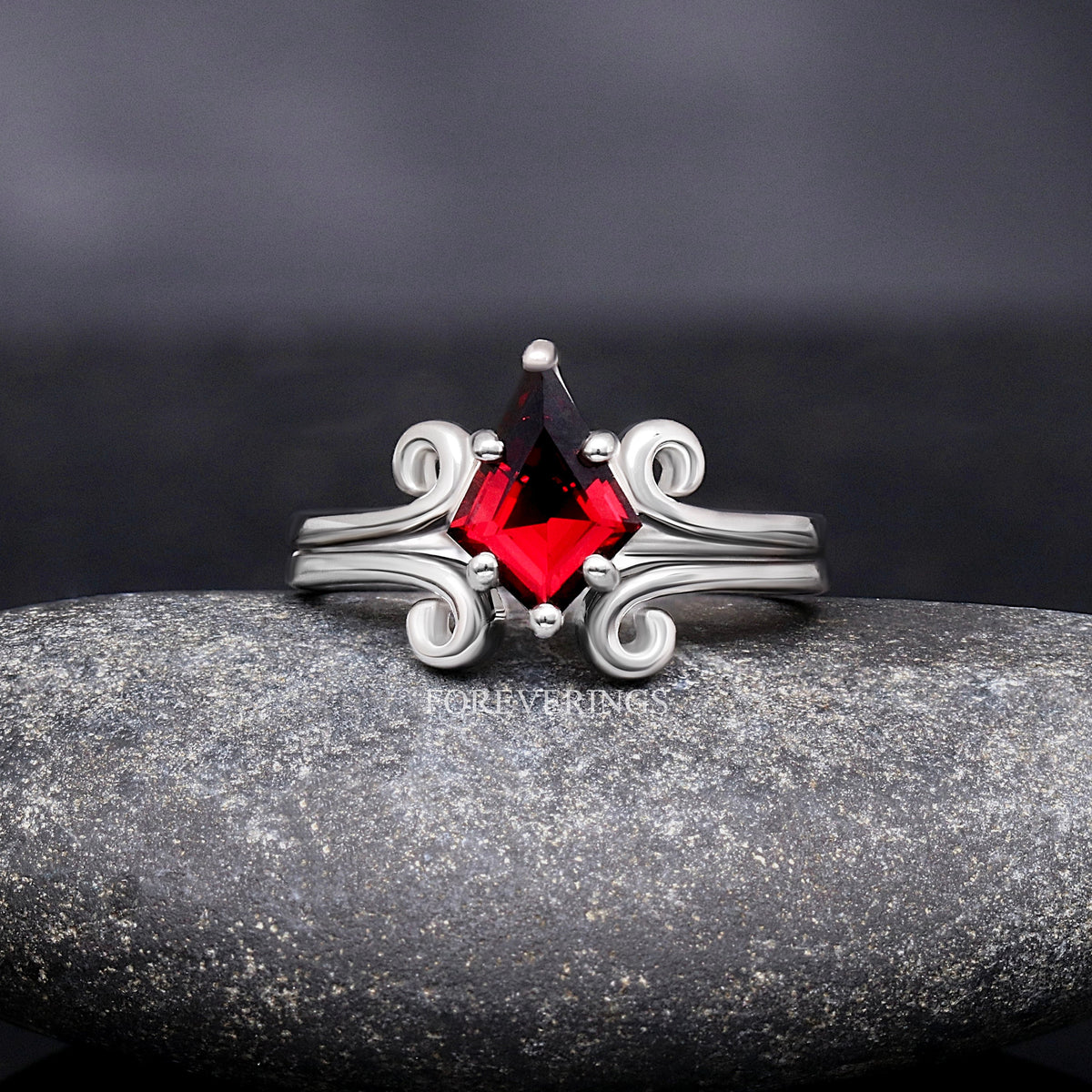 Women's sterling silver kite cut garnet ring with swirl details, shown straight on