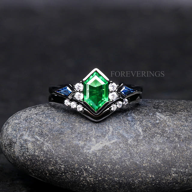 Women's black sterling silver engagement ring set with a hexagon tsavorite and blue side stones, front view