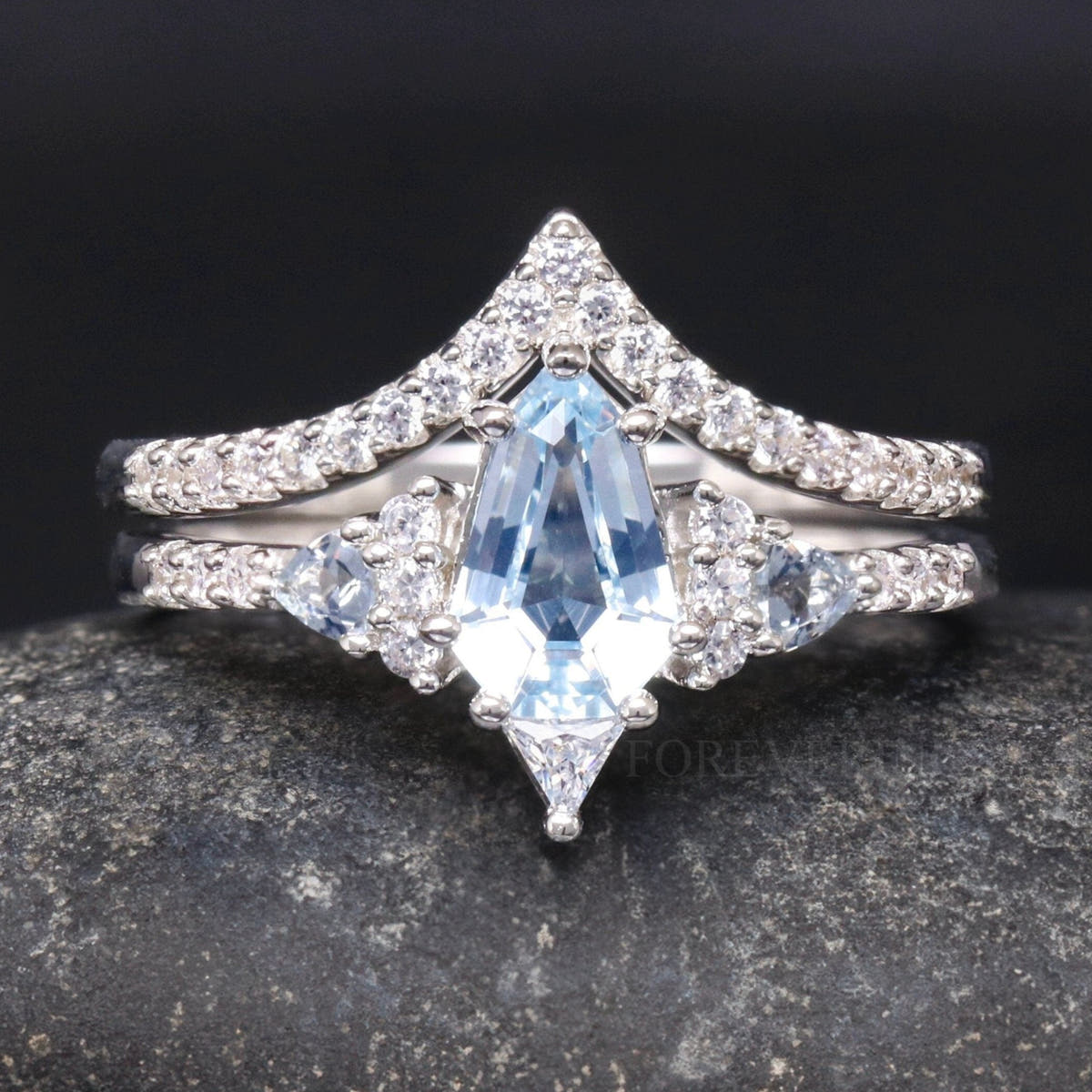 Women's sterling silver shield-cut aquamarine bridal set with chevron band, close front view