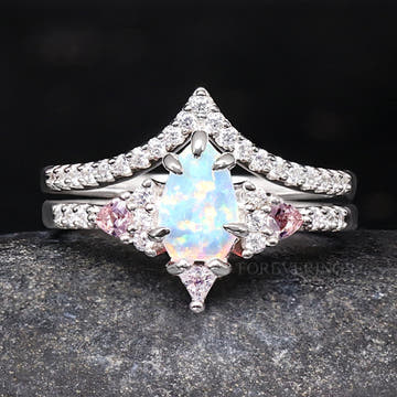 White opal bridal set in sterling silver with pink morganite side stones and a curved band, front view