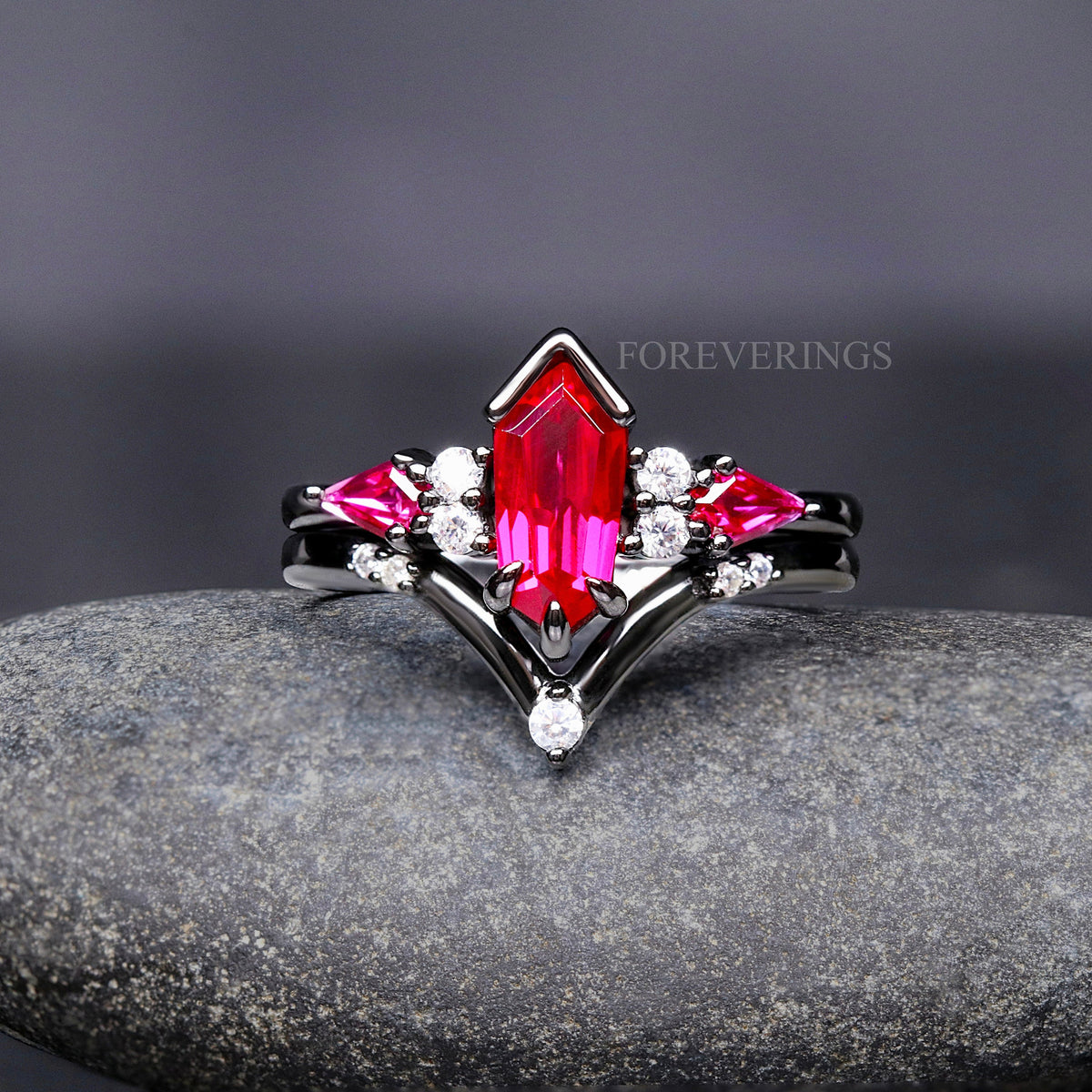 Black sterling silver ruby engagement ring with a chevron band, shown straight on