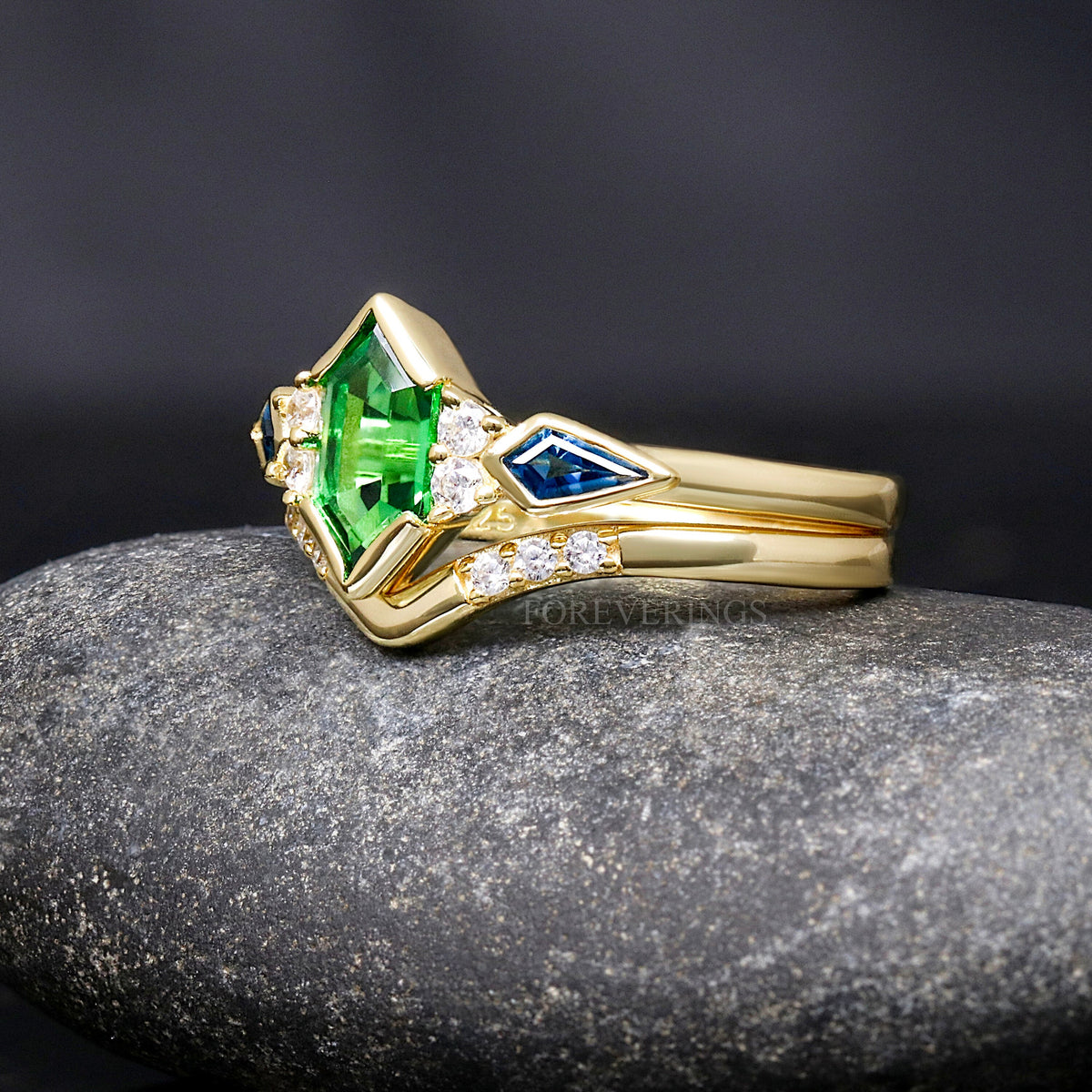 Gold sterling silver tsavorite engagement ring and chevron band, angled side view