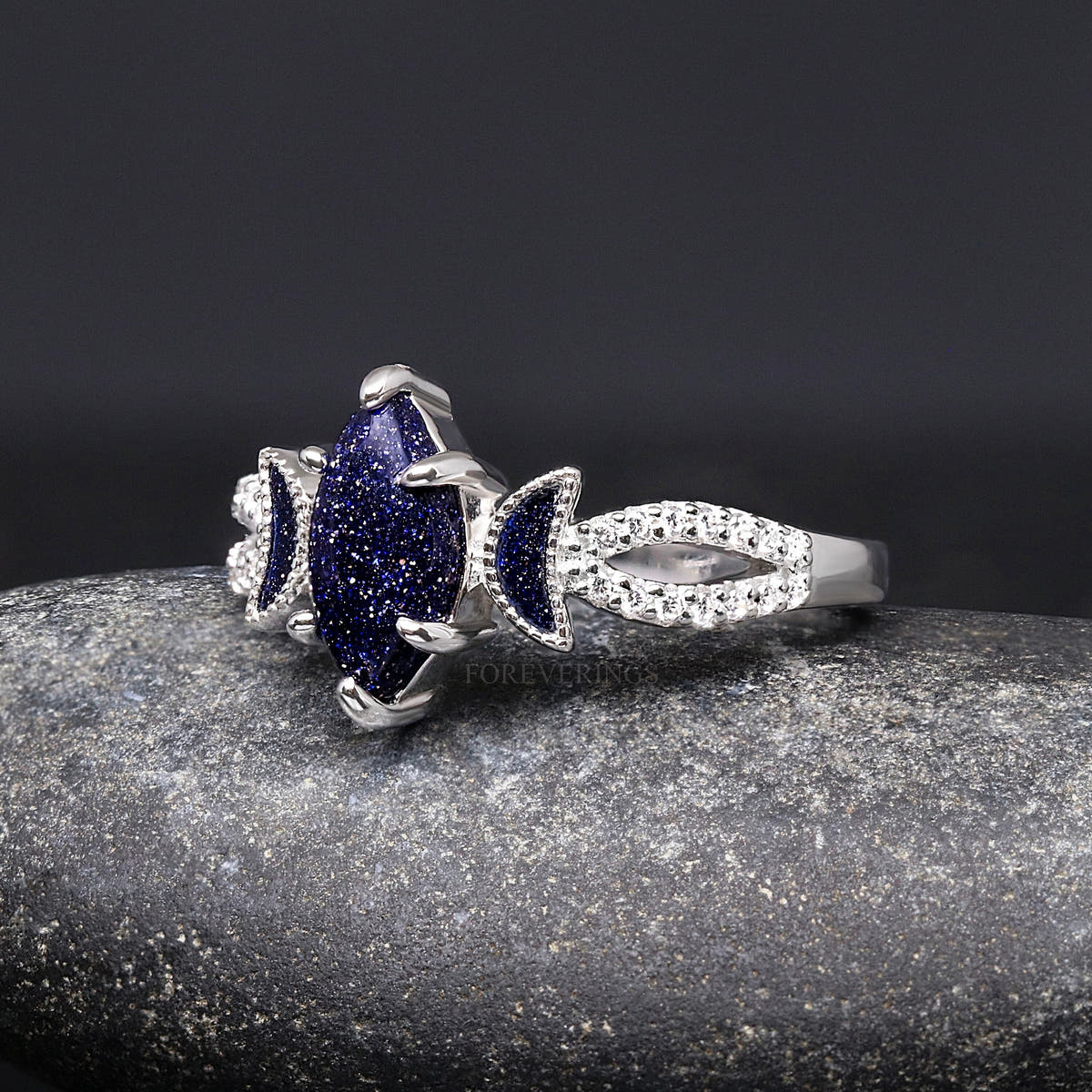 Sterling silver marquise blue sandstone ring with stone-lined band, angled side view