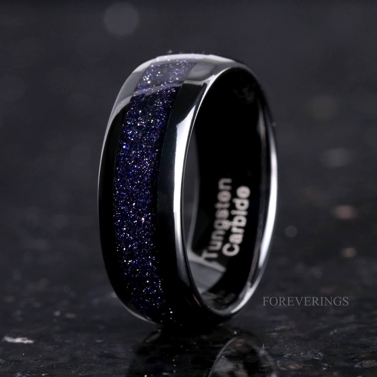 Men's 8mm black tungsten band with blue sandstone inlay, angled to show the interior
