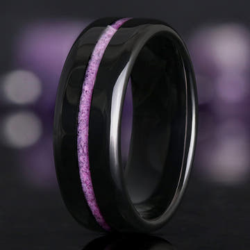 Men's 8mm black tungsten wedding band with a crushed purple turquoise inlay, standing at an angle