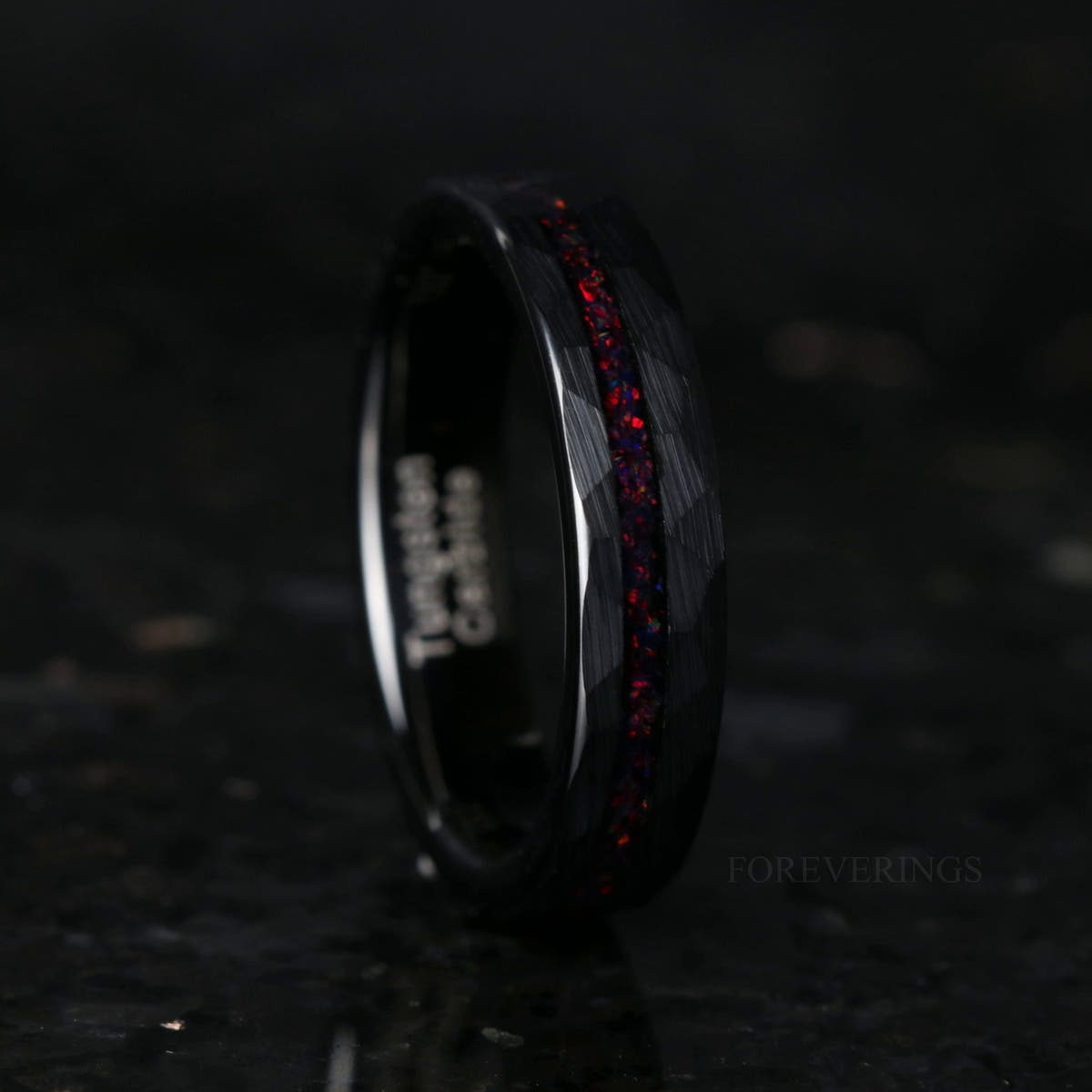 Offset black fire opal ring in hammered black tungsten, wider side view
