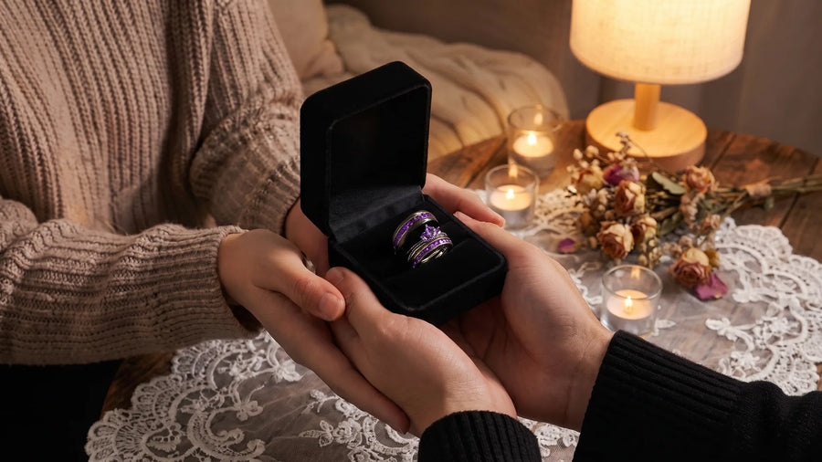 Couple picking out wedding rings together at a table with ring sets