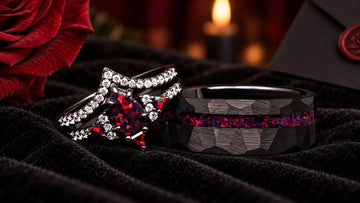 Gothic wedding flat lay with black candles, dark roses, and matching black couples rings