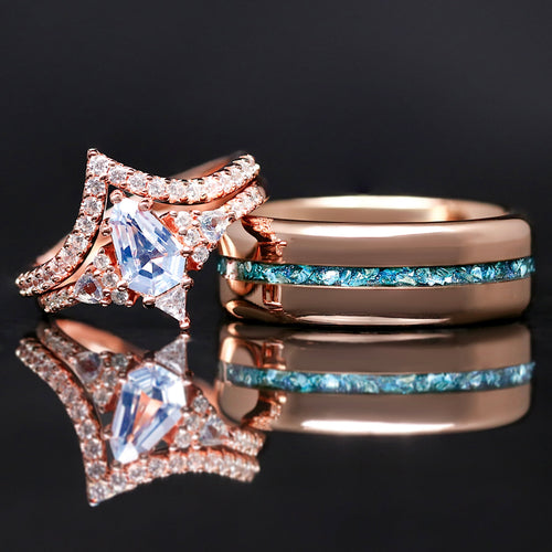 Two rose gold rings with gemstones on a reflective surface