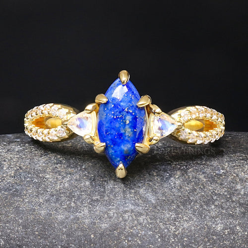 Women's gold sterling silver engagement ring with a marquise lapis lazuli and moonstone side stones
